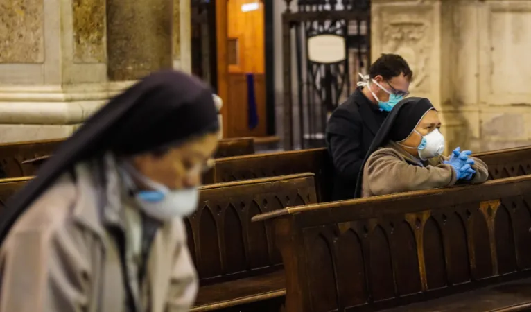 Fedeli in chiesa | Fedeli pregano con mascherina in chiesa | LN